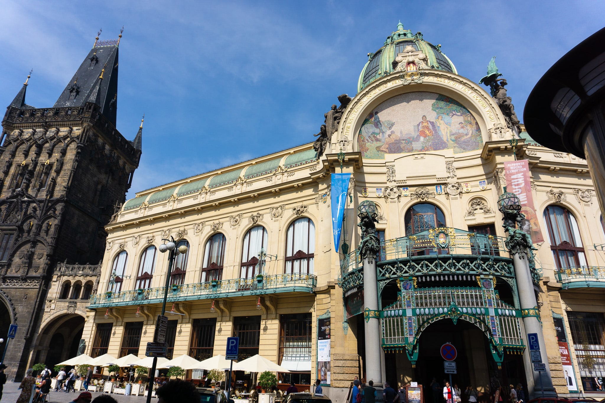 Municipal House beside the Powder Gate in Prague, showing Art Nouveau ornament next to a dark Gothic tower.