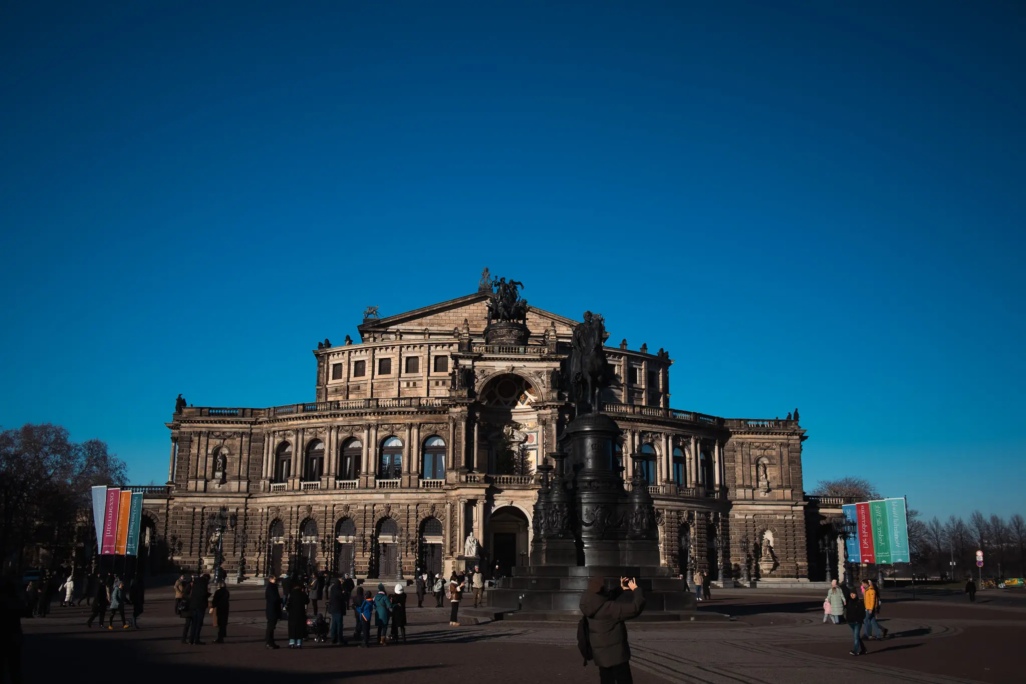 Historic cultural building and equestrian statue on a wide square in Dresden