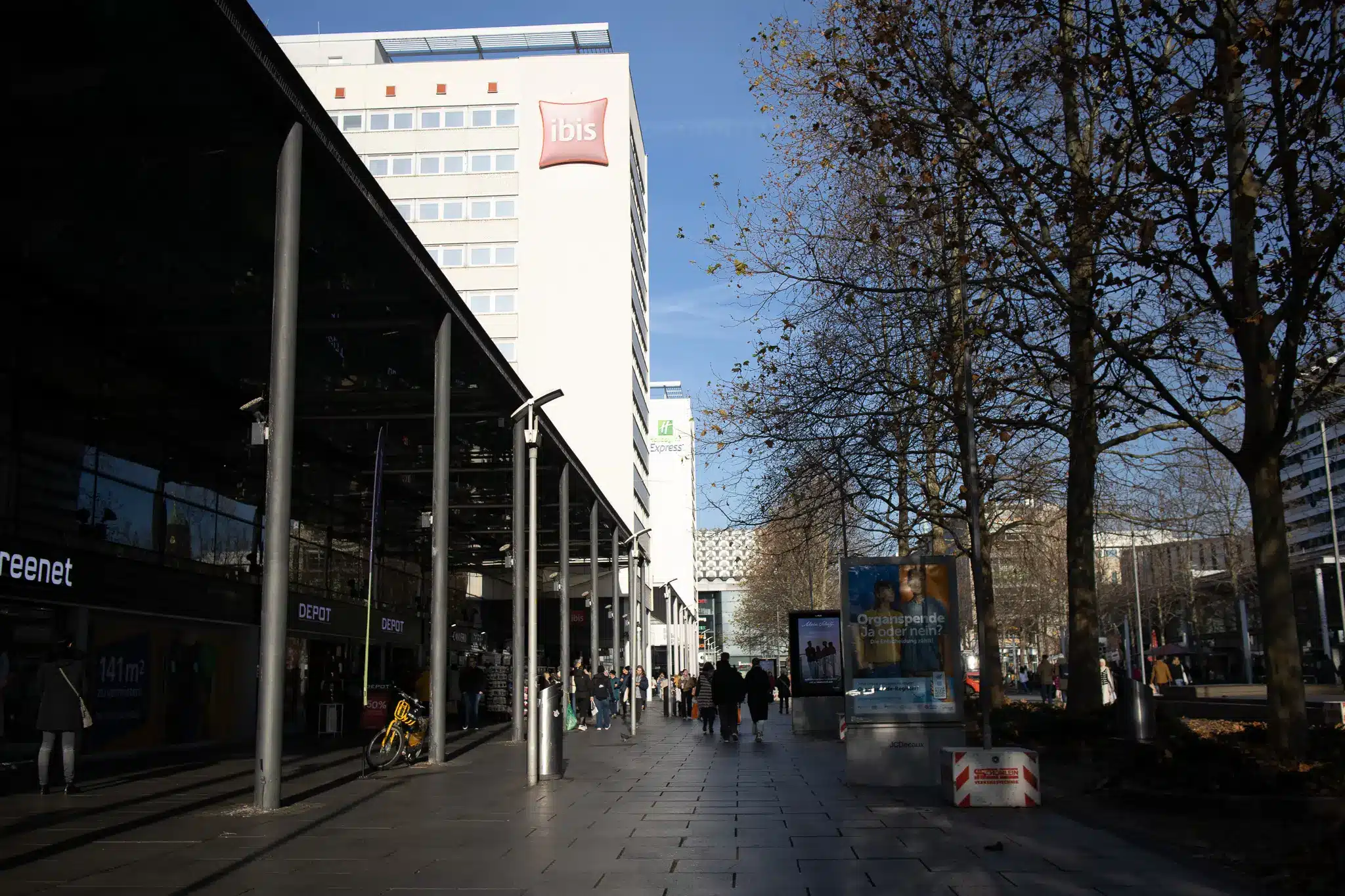 Pedestrian walkway with ibis and Holiday Inn Express signs in central Dresden