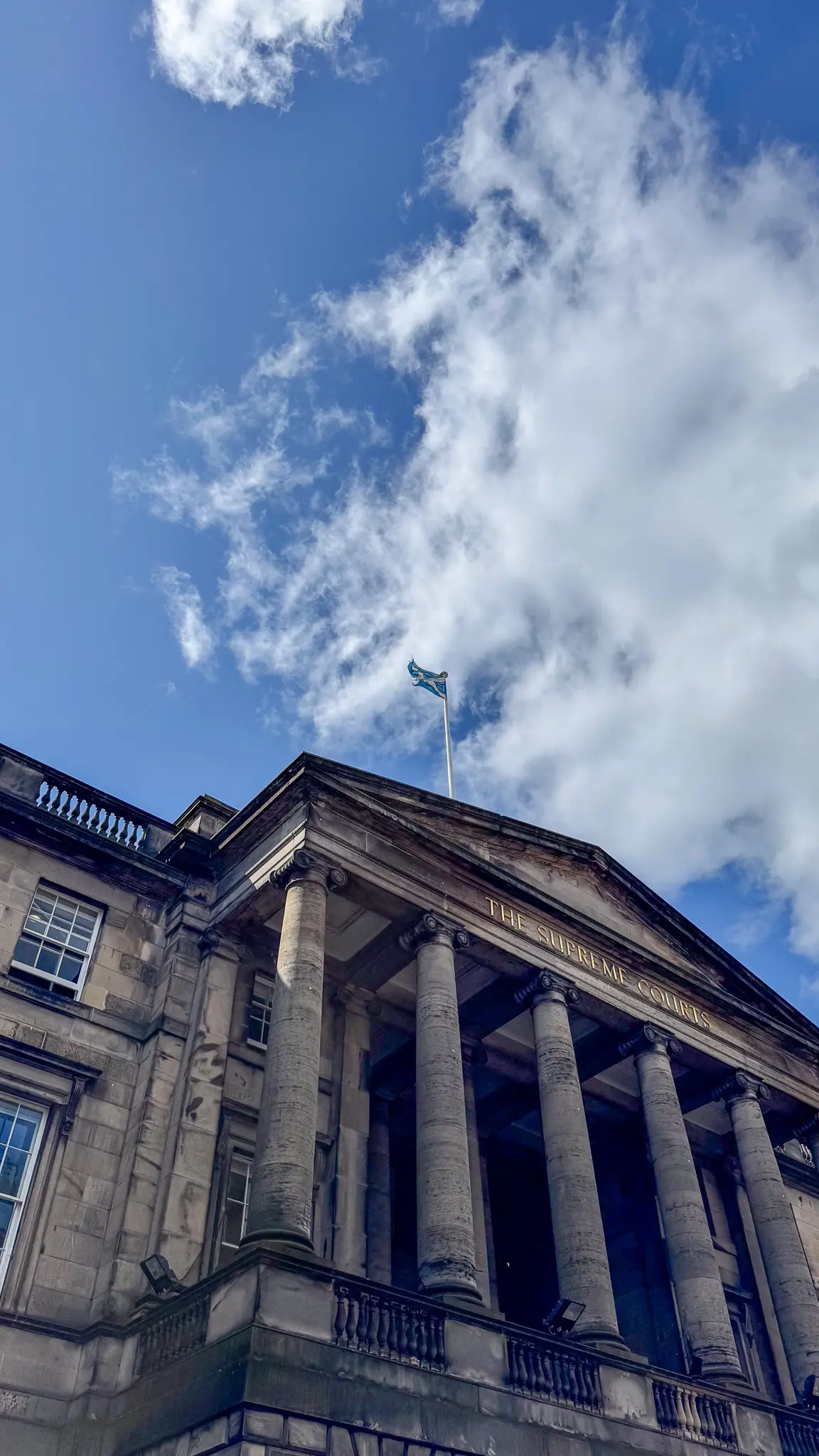 Neoclassical façade of the Supreme Courts of Scotland with gold lettering
