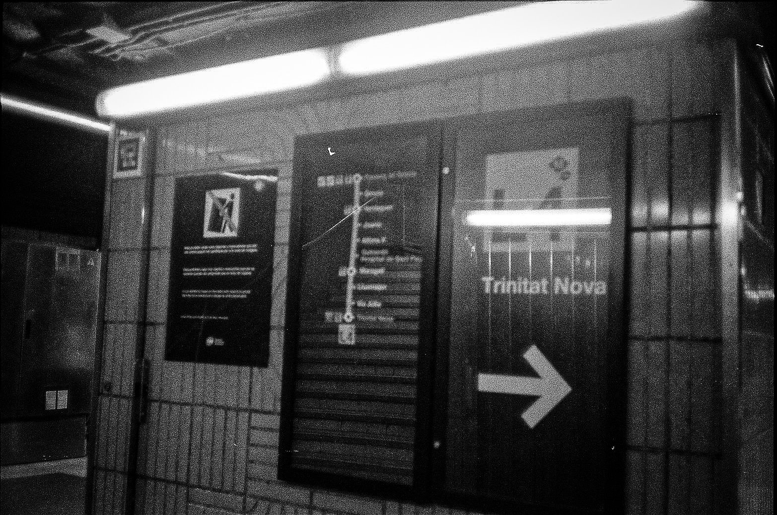 Trinitat Nova station signage on a tiled transit wall in Barcelona