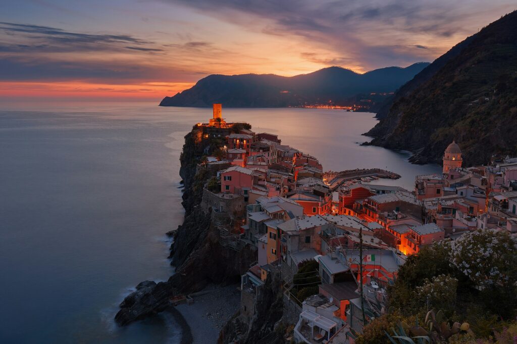 The coastal village of Vernazza in Italy under a warm orange sky