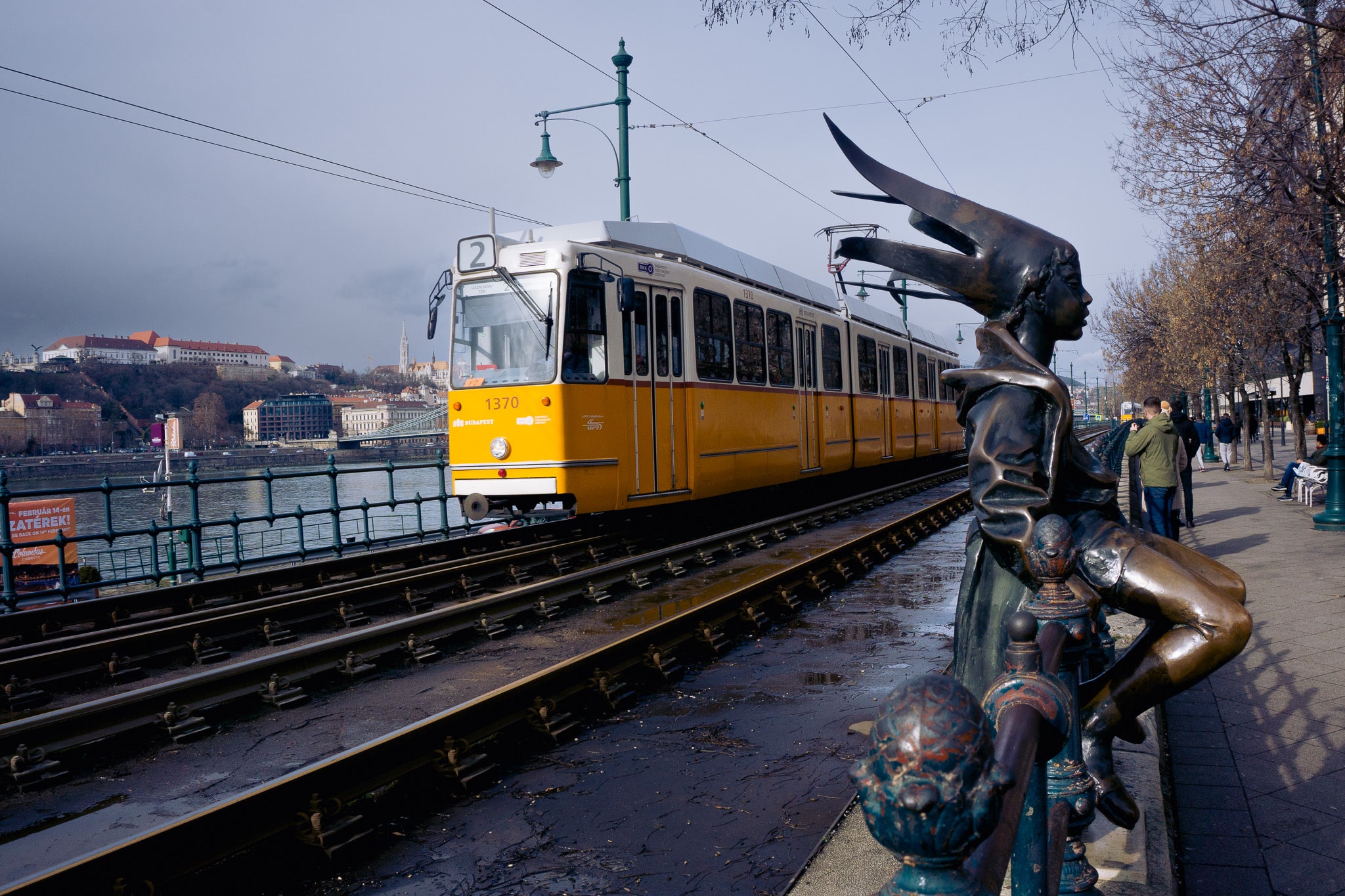 Budapest tram line 2 passing sculpture and riverside promenade along the Danube