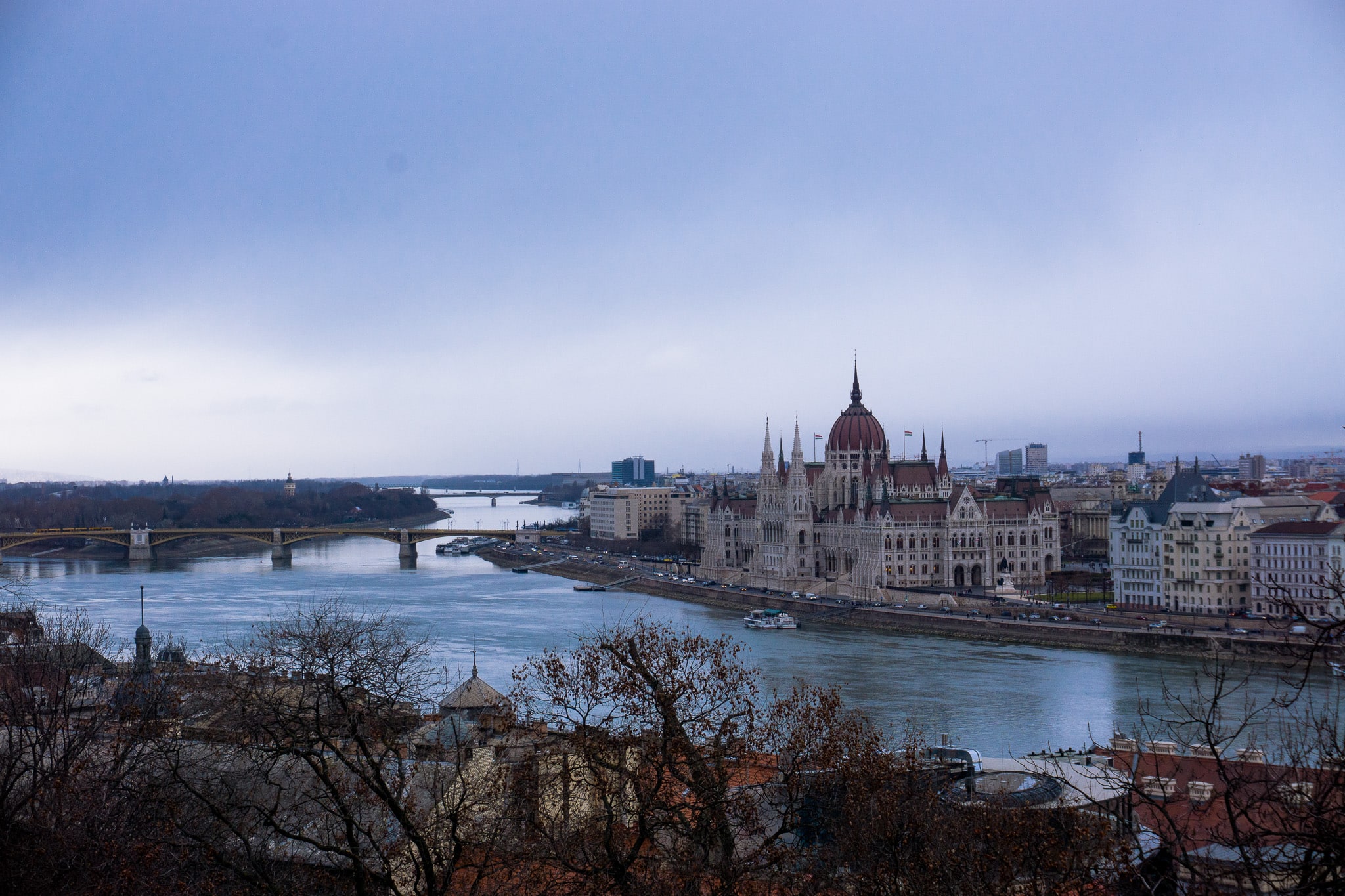 View across the Danube to the Hungarian Parliament Building and Budapest embankment under overcast skies