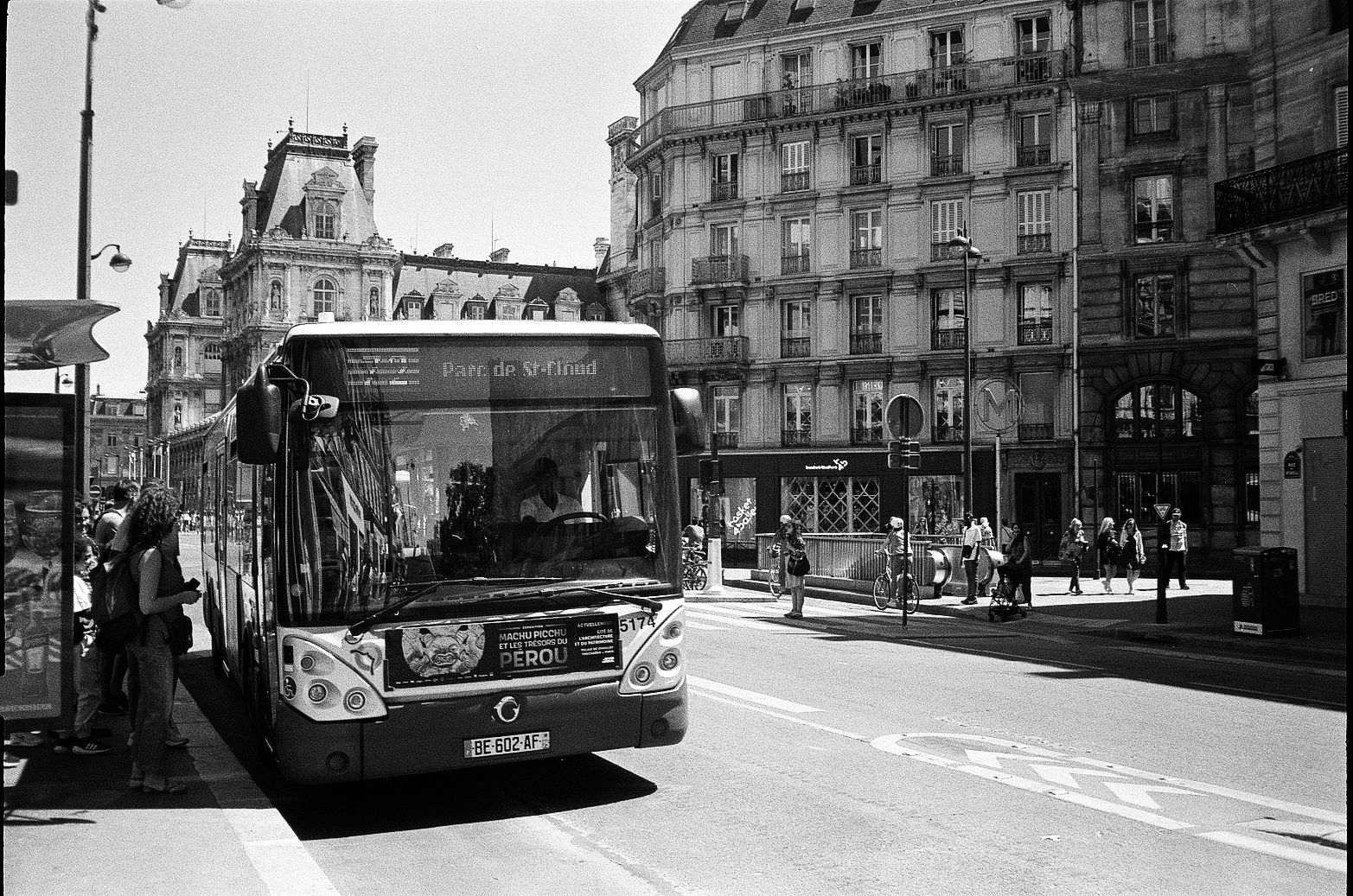 Paris city bus displaying Parc de St-Cloud destination on a boulevard lined with historic buildings