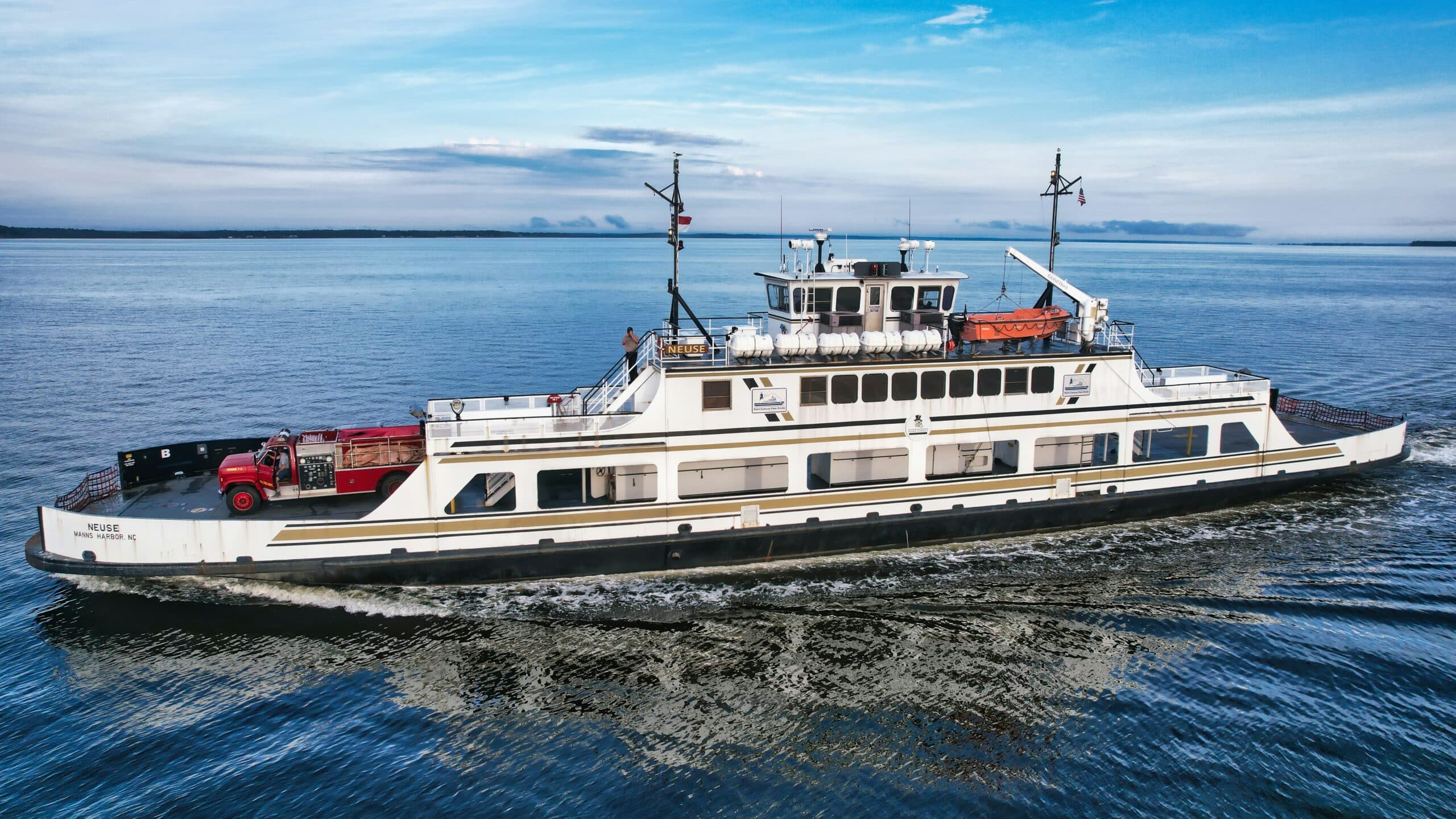a large white boat traveling across a body of water