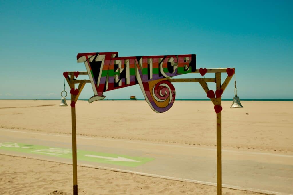Venice sign on a sandy beach boardwalk