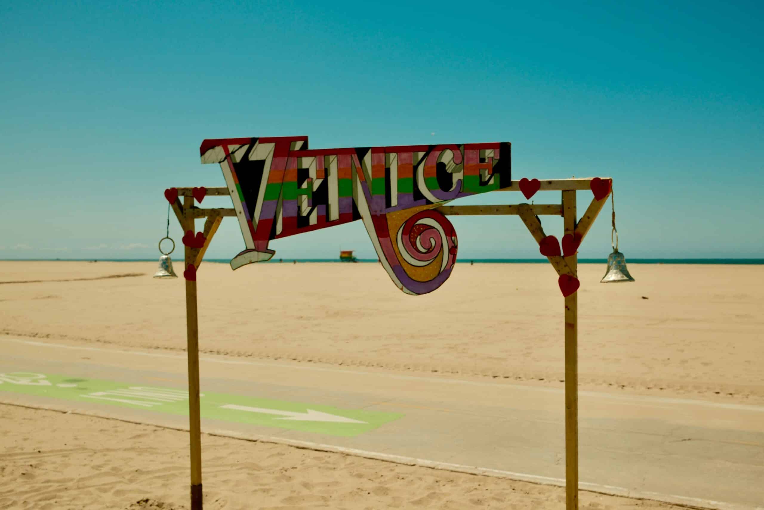 Venice sign on a sandy beach boardwalk